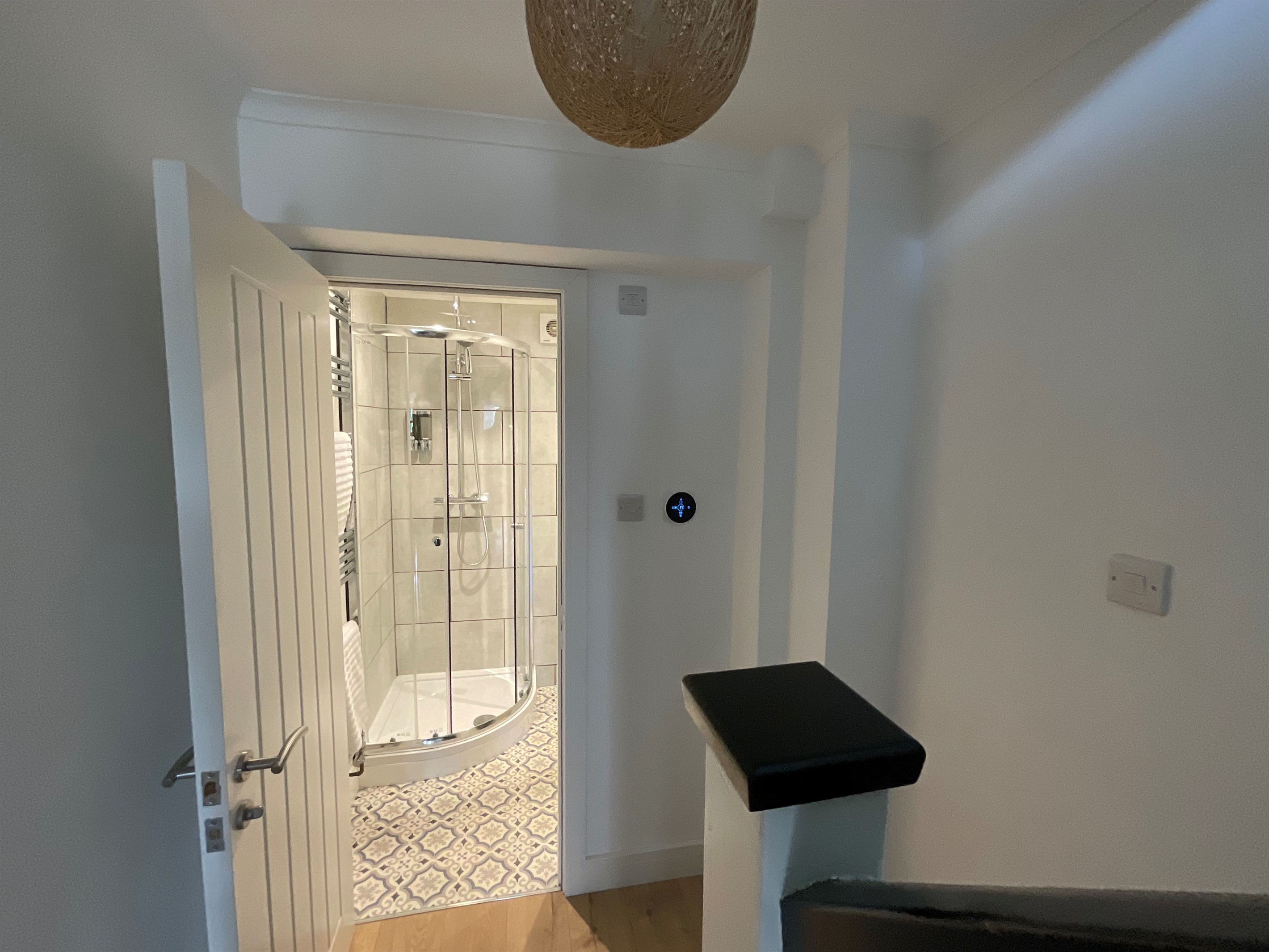 The downstairs shower room.  The smart thermometer on the wall allows guests to boost the heating.