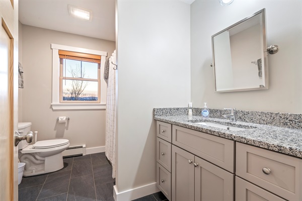 Convenient second-floor bathroom with standing shower and toilet