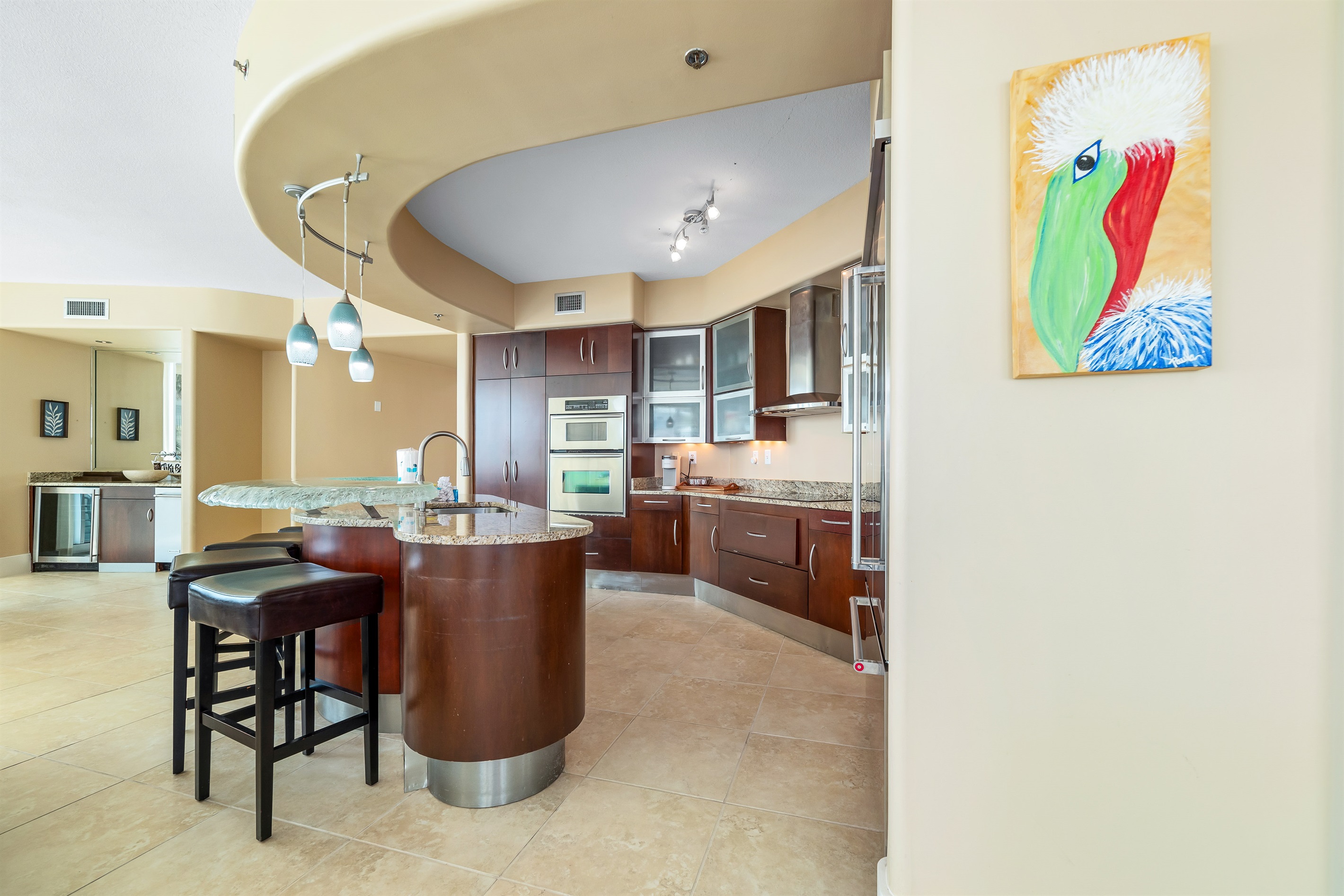 The kitchen island takes center stage, offering ample counter space and casual seating. Perfect for meal prep, entertaining, and everyday living.