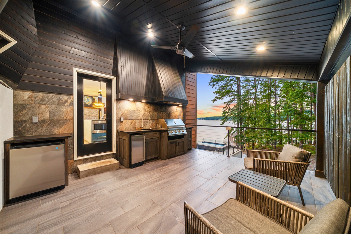 Covered outdoor lounge with bar and seating designed for relaxation.
