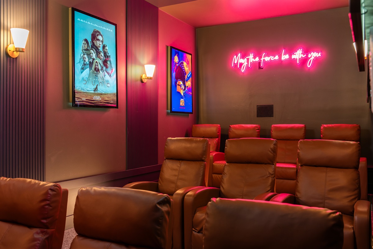 Private theatre room with reclining seating and ambient lighting - perfect for relaxed movie nights at home