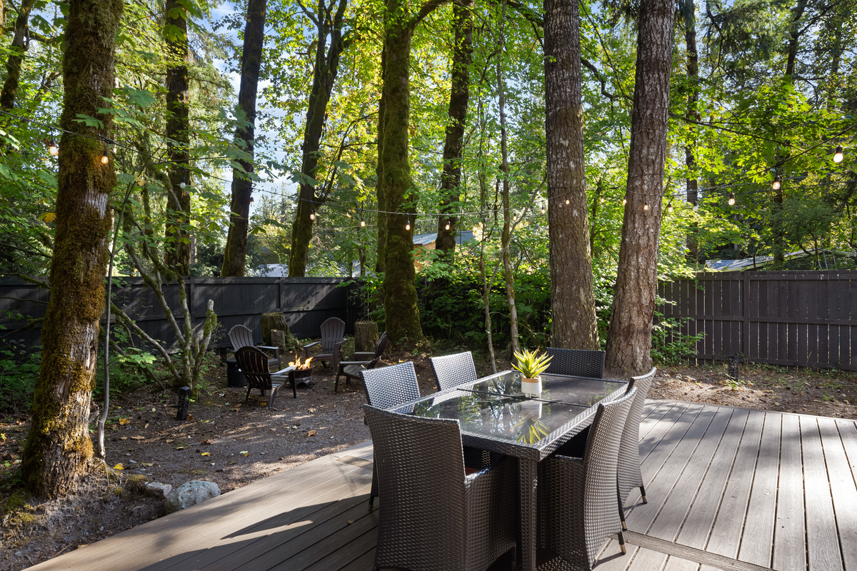 Dinner table by day, fire pit glow by night — all steps from your back door.