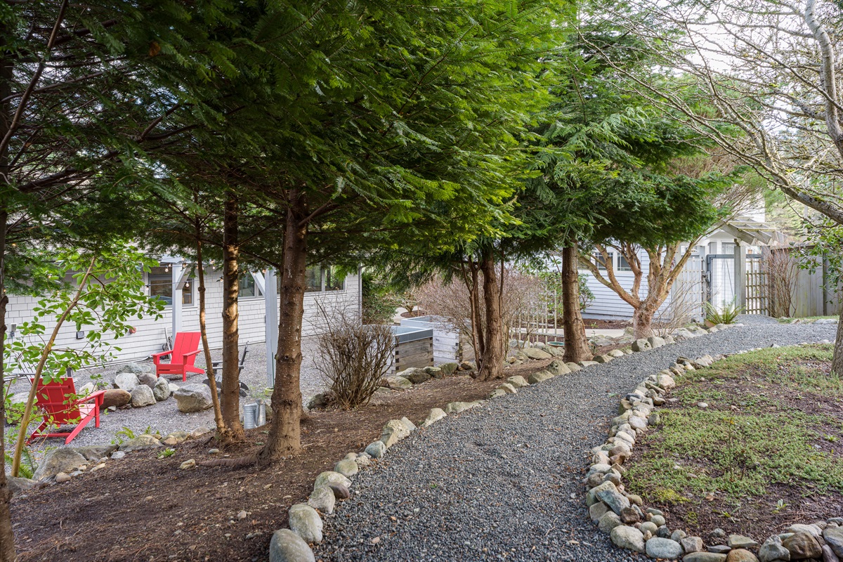 Stroll the gravel-lined path alongside your private outdoor retreat that includes fire pit and hot tub. This also makes for an amazing kid racetrack to get all those extra wiggles out!