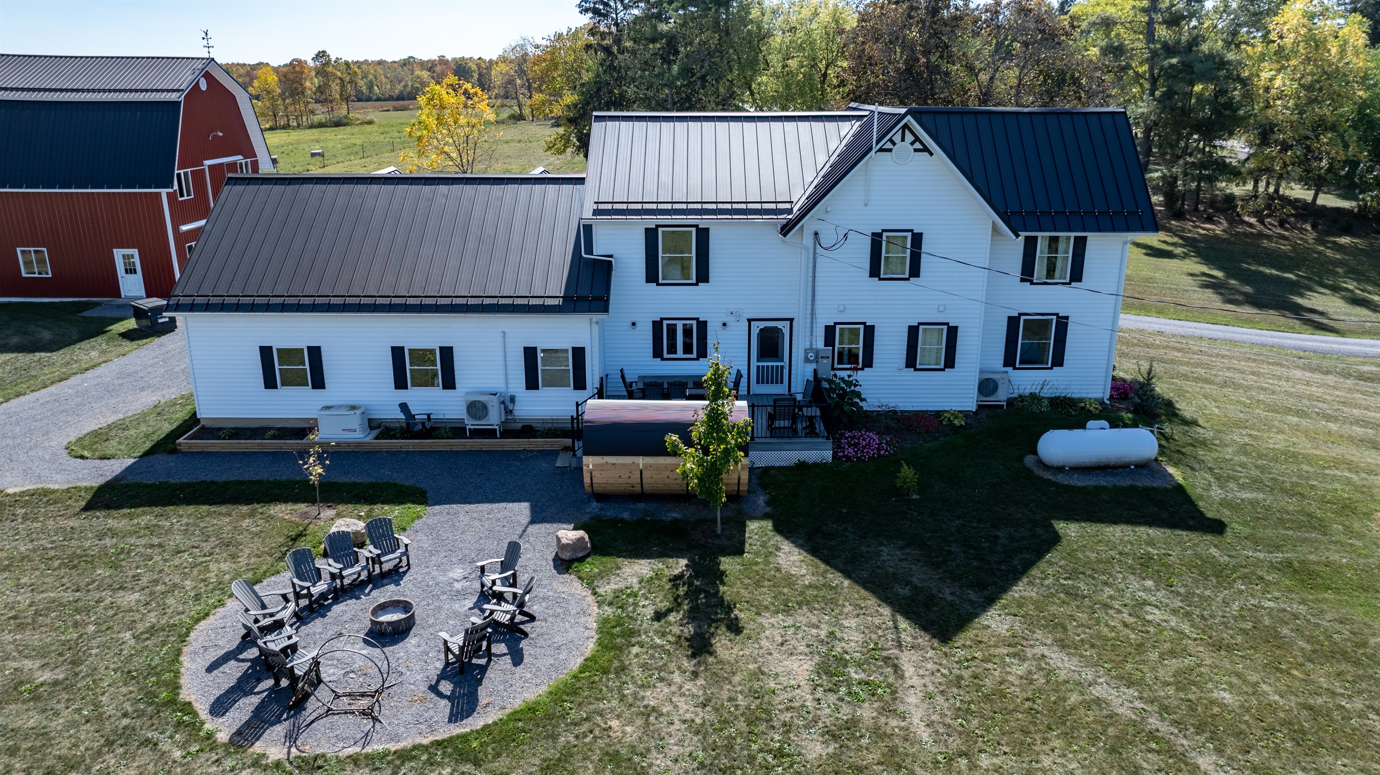 Bright white farmhouse with patio seating — perfect for morning coffee or evening wine under the stars