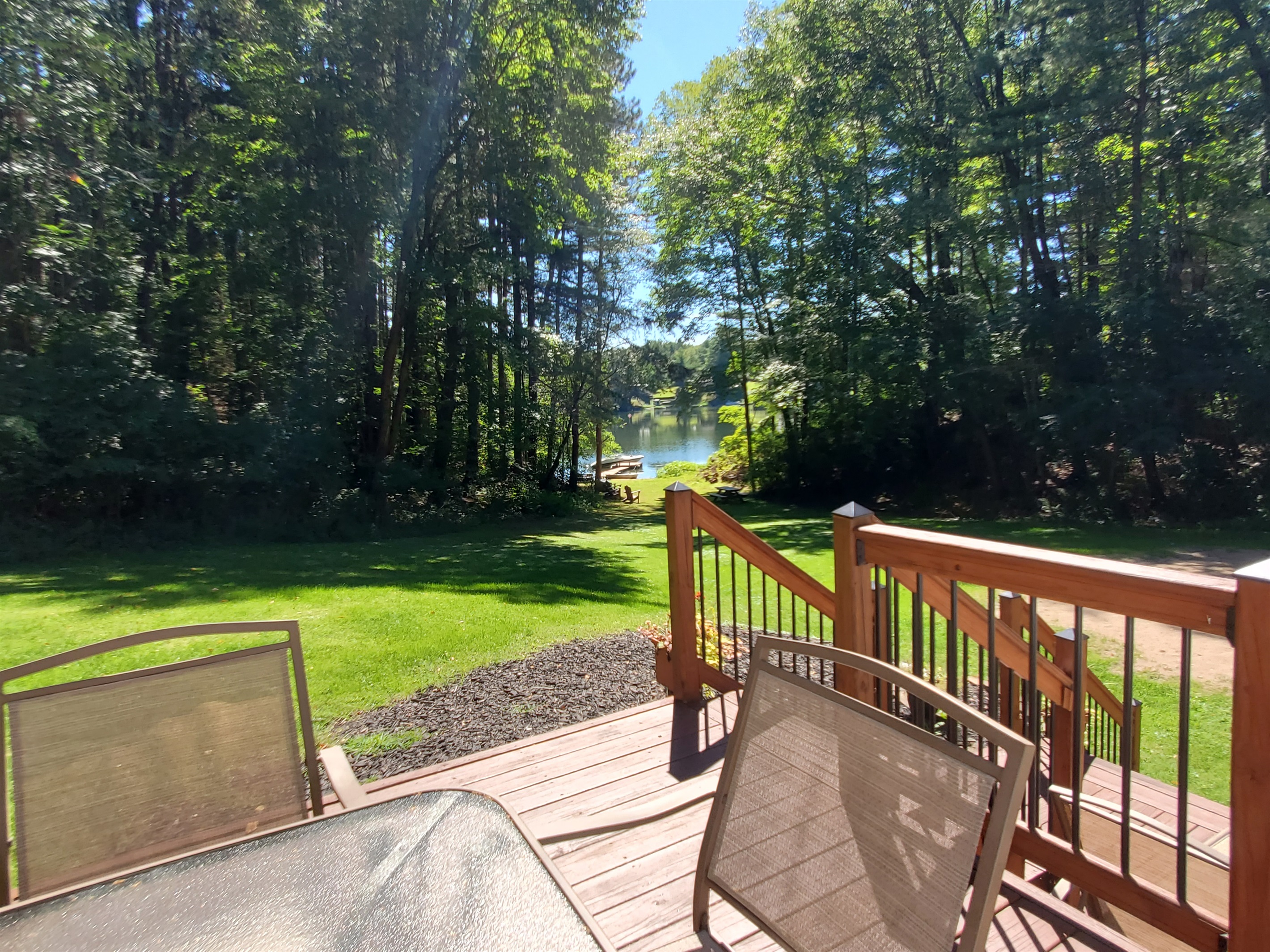 Outdoor dining with water in at lawn's edge distance