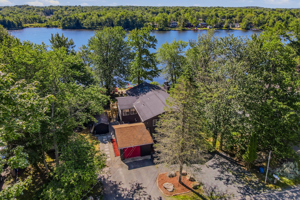 Aerial view of Élevé Lake Lodge nestled in the trees above Lake Carobeth