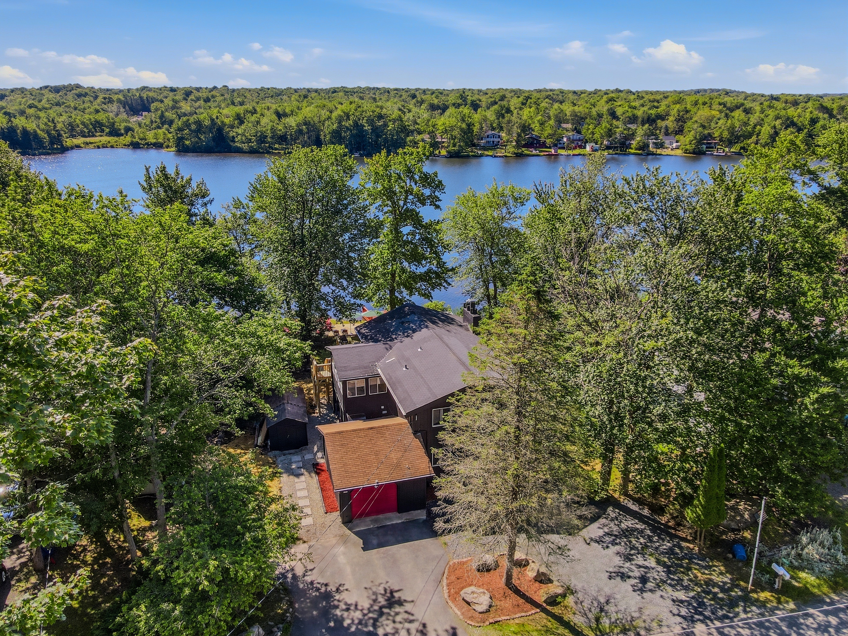 Aerial view of Élevé Lake Lodge nestled in the trees above Lake Carobeth