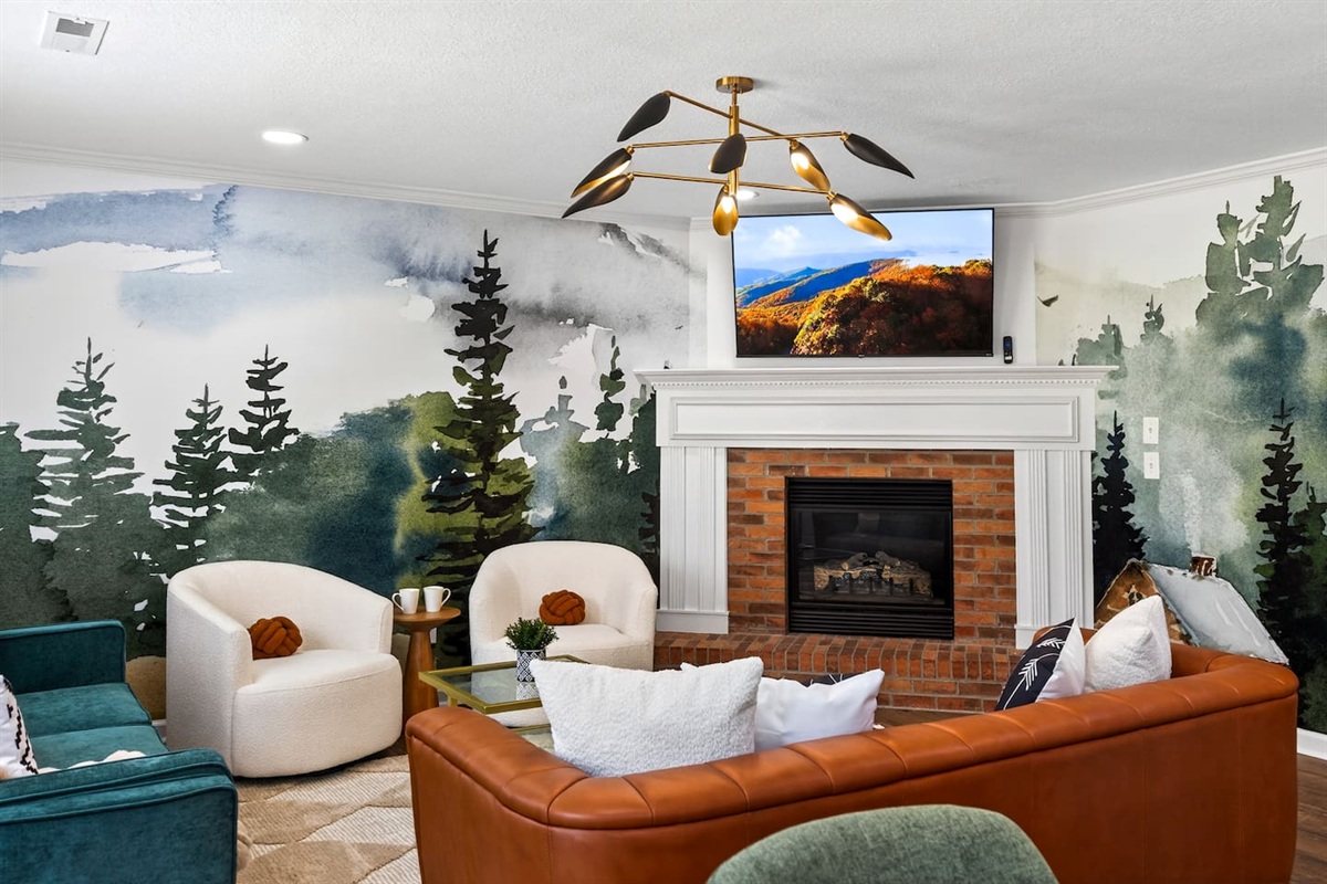 Mural lined living space with leather couch and stylish furnishings perfect for gathering.