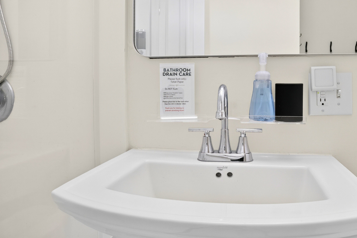 Bathroom vanity with thoughtful guest amenities.