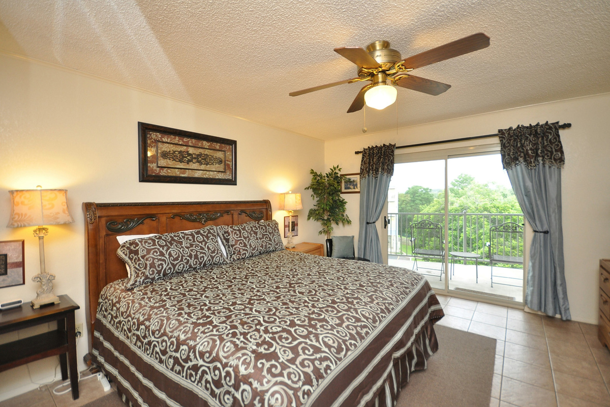 Spacious primary bedroom with access to double balcony.