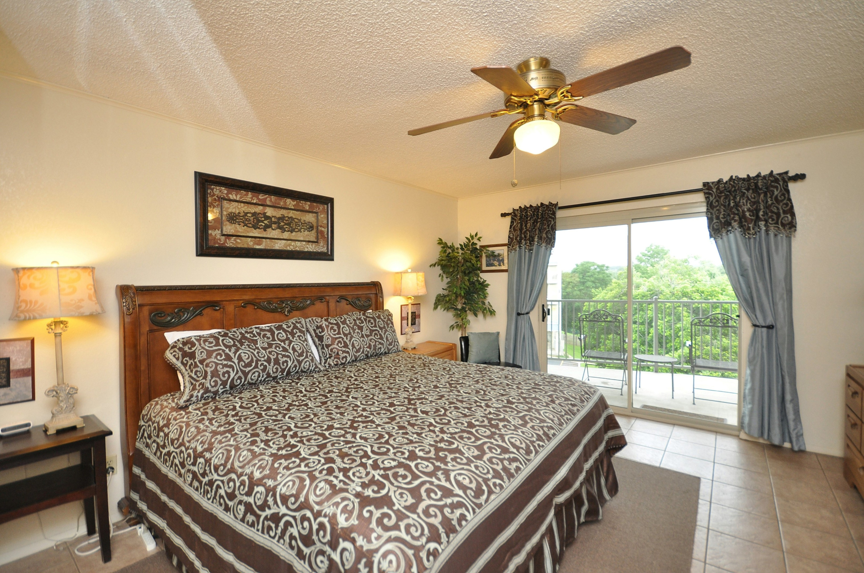 Spacious primary bedroom with access to double balcony.
