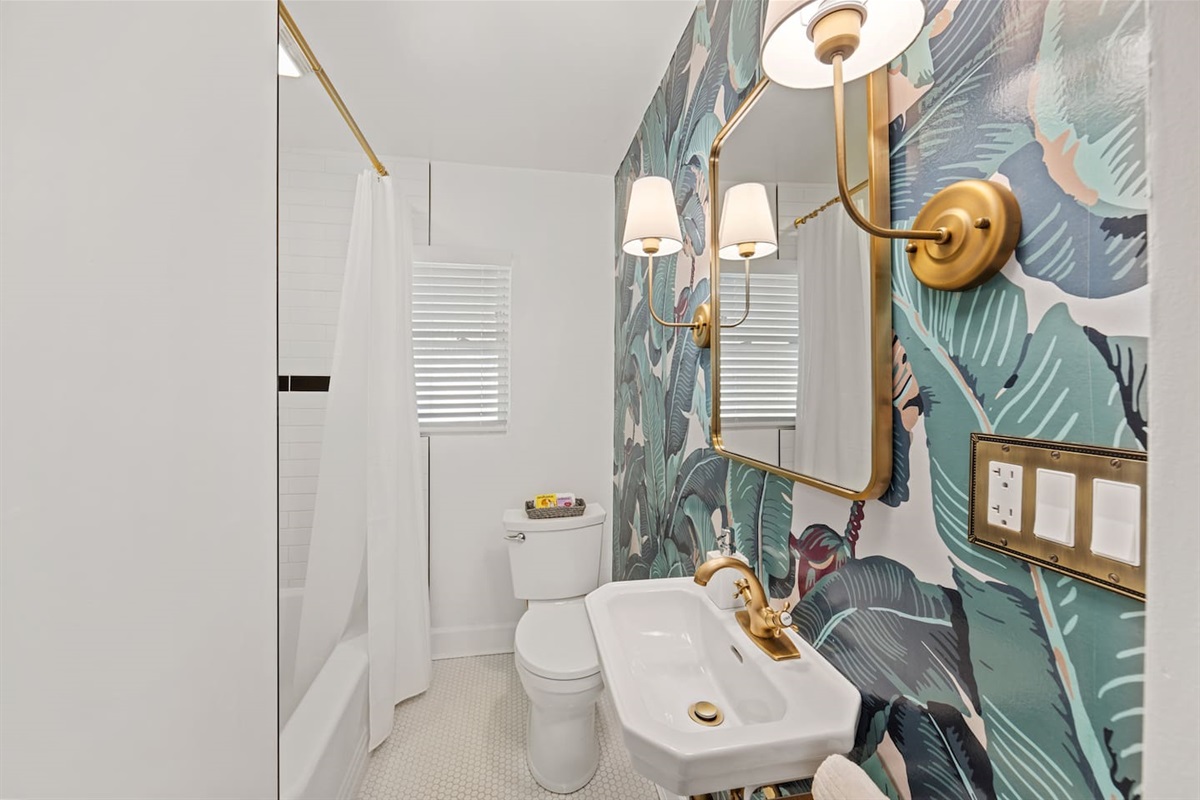 Main bathroom is a retro design featuring original wallpaper from Beverly Hills hotel (circa 1920).  Refinished original cast-iron full size bathtub.