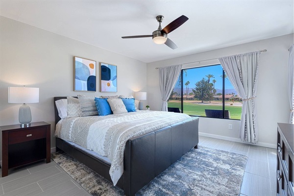 Main bedroom with king bed, patio access, and golf course view