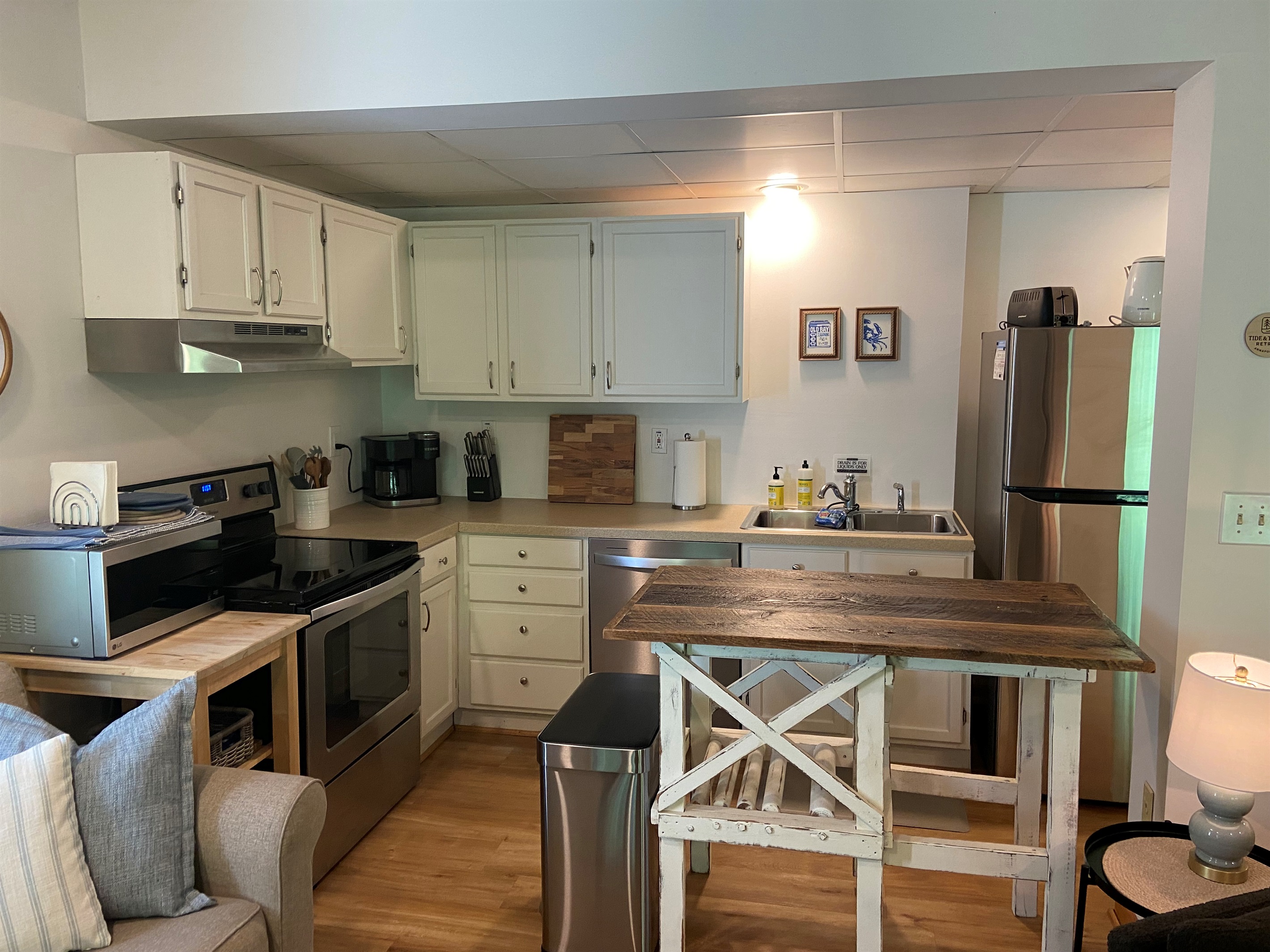 Kitchen includes full-sized appliances and extra counter space for meal prep and spreading out. The kitchen is well appointed for cooking a meal.