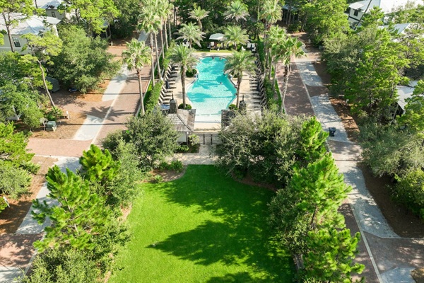Resort-Style Pool - A quick walk through the stone path across the street takes you to the pool shared only with Creek Park at Magnolia homes. Surrounded by palms and lounge chairs, it’s perfect for swimming, relaxing, and soaking up the 30A sun.