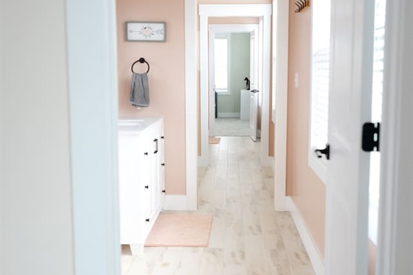 View from doorway of bedroom #4 looking through private vanity/sink area to bedroom #5. Two sliding doors and two regular doors (plus privacy doors on toilet and shower areas) provide the option for privacy between these two rooms.