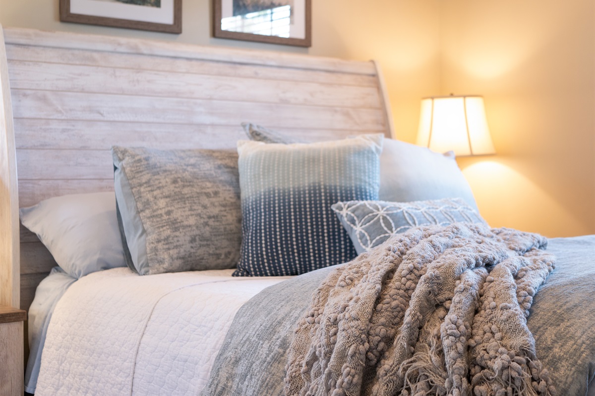 Plush bedding and soft coastal tones for a restful night&rsquo;s sleep