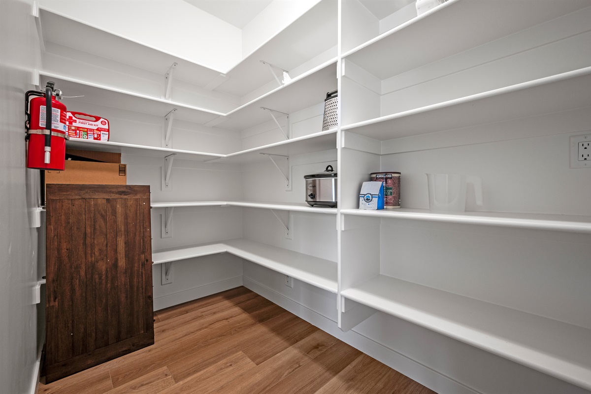 A spacious kitchen pantry offers plenty of room to store your food, snacks, and supplies.