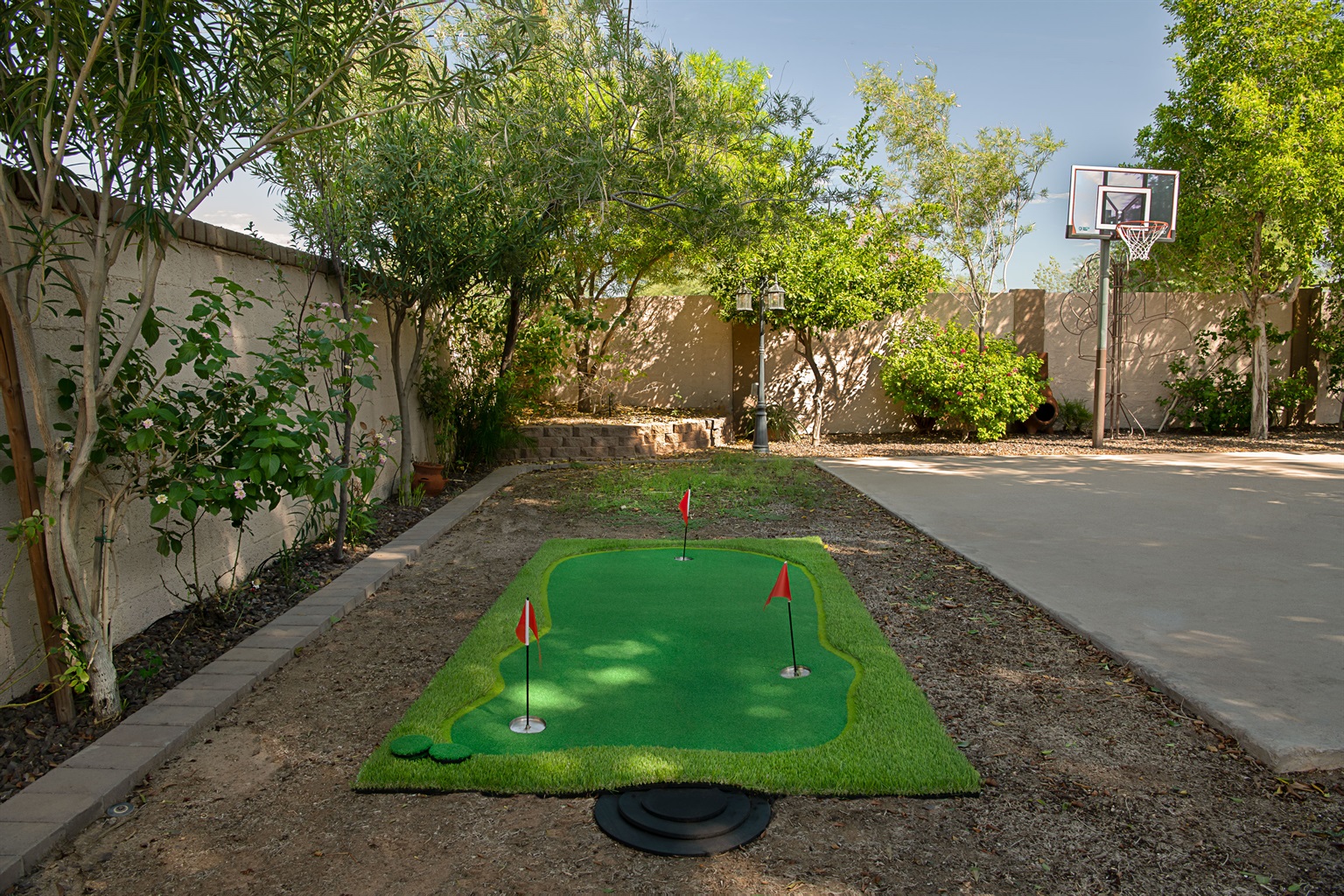 Enjoy endless outdoor fun with your own private putting green and basketball hoop, surrounded by shade trees and sunshine.
