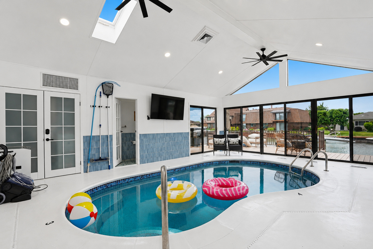 Have fun and relax in the bright indoor heated pool, featuring skylights, vaulted ceilings, and sliding doors that open to the deck and waterfront views.