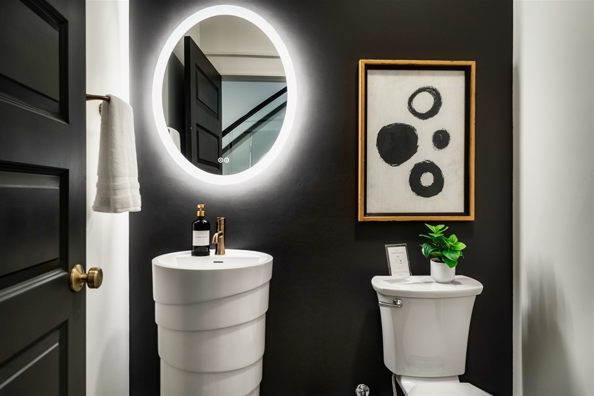 Thoughtfully designed half-bathroom featuring modern fixtures and a sleek vanity.
