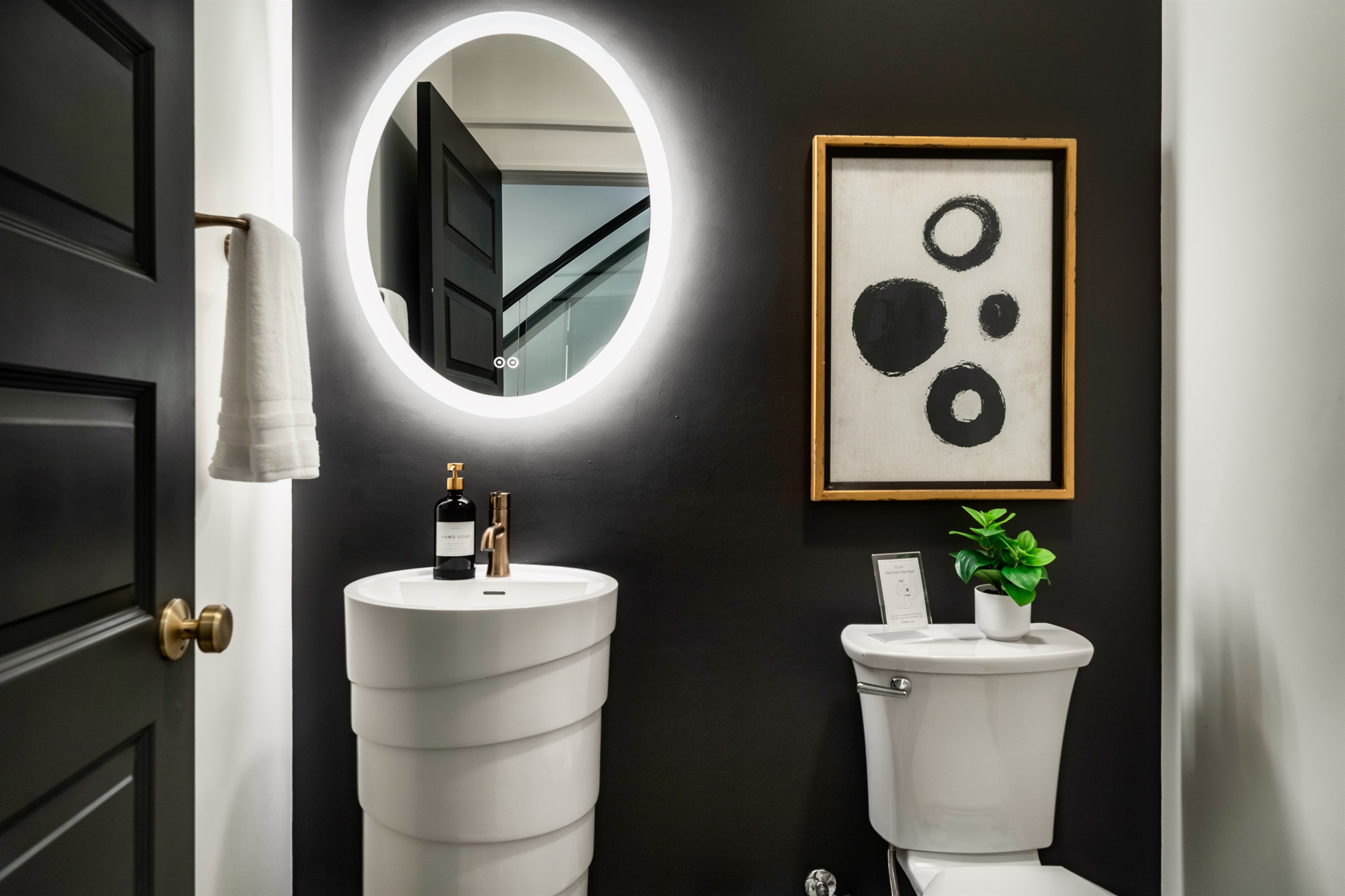 Thoughtfully designed half-bathroom featuring modern fixtures and a sleek vanity.