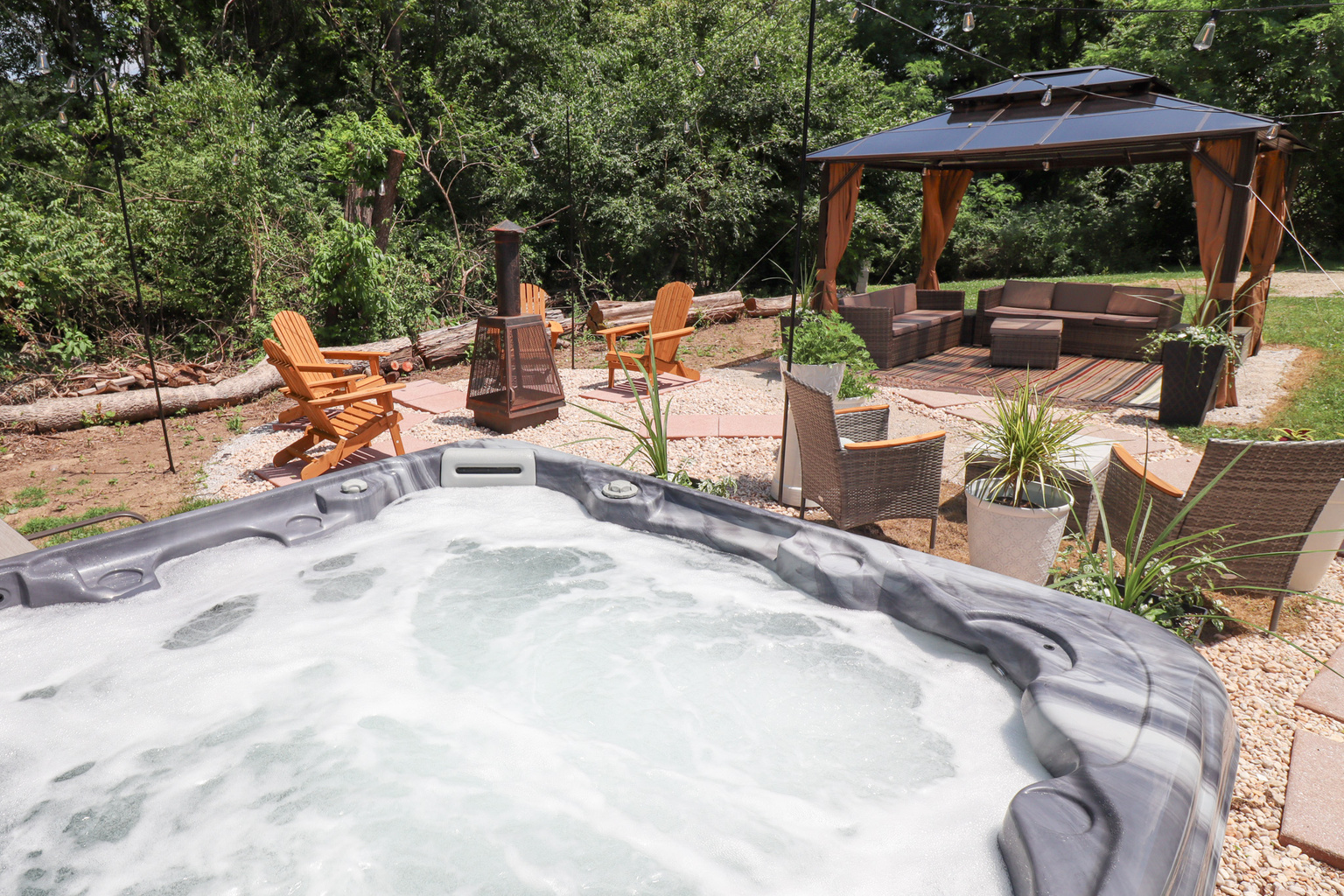 Private backyard oasis is designed for relaxing, gathering, and making memories