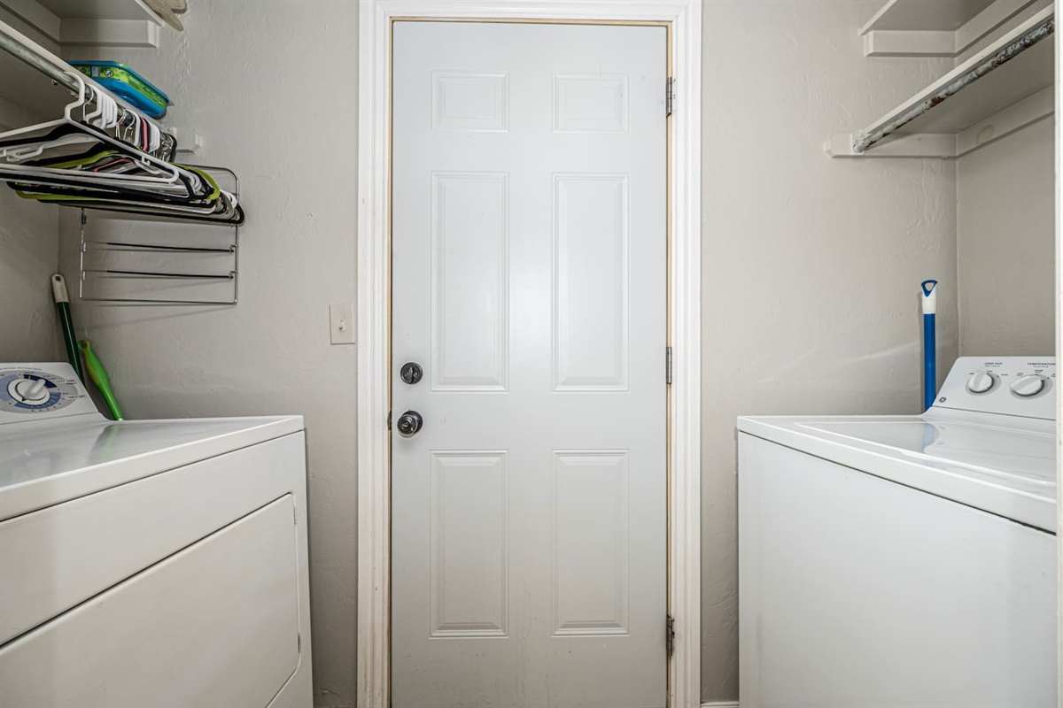 Tidy laundry space with washer and dryer for guest use.
