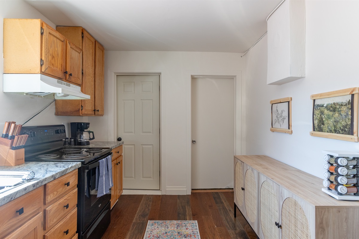 A kitchen with a stylish hutch and plenty of character