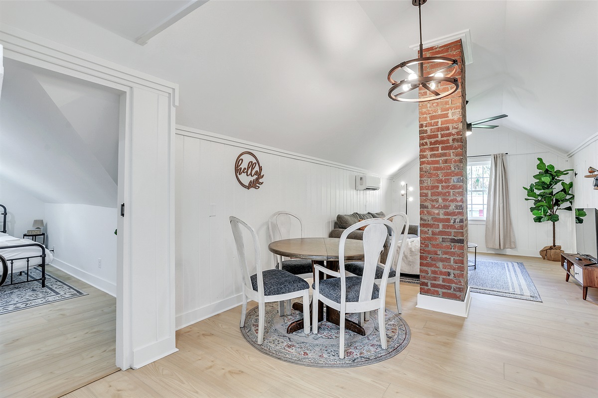The open dining area sits perfectly between the kitchen and living room—ideal for easy meals and seamless conversation