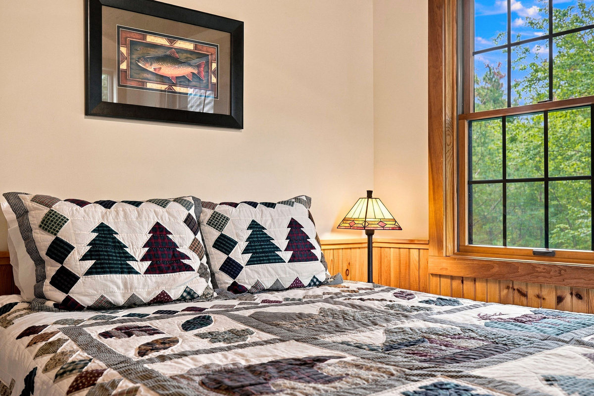 Large windows fill this welcoming bedroom with natural light.