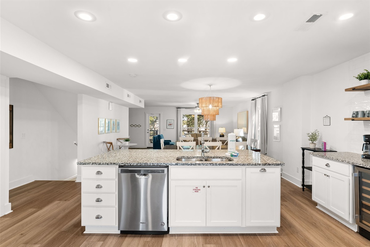 Side B: Open 2nd-floor layout connects the kitchen, dining and living areas seamlessly.