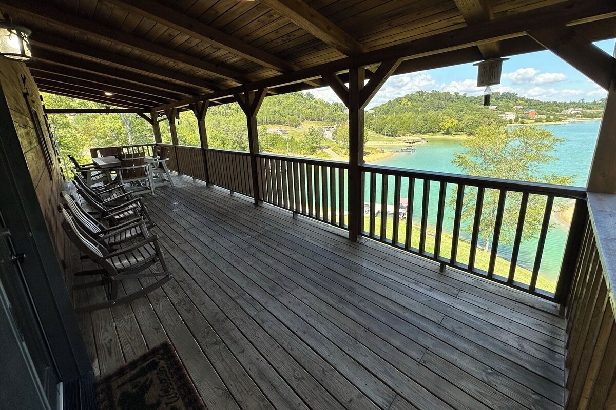 This top porch on the cabin back overlooks the lake and has great quality outdoor furniture with rocking chairs and a a large table in the back for games or eating. 