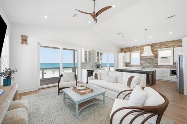The top level living room has a sofa, two chairs, poufs, and room to gather.