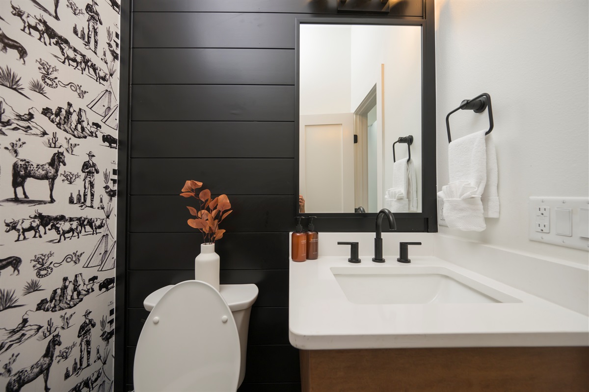 Half bathroom with chic modern design. Conveniently located near the main living area. 