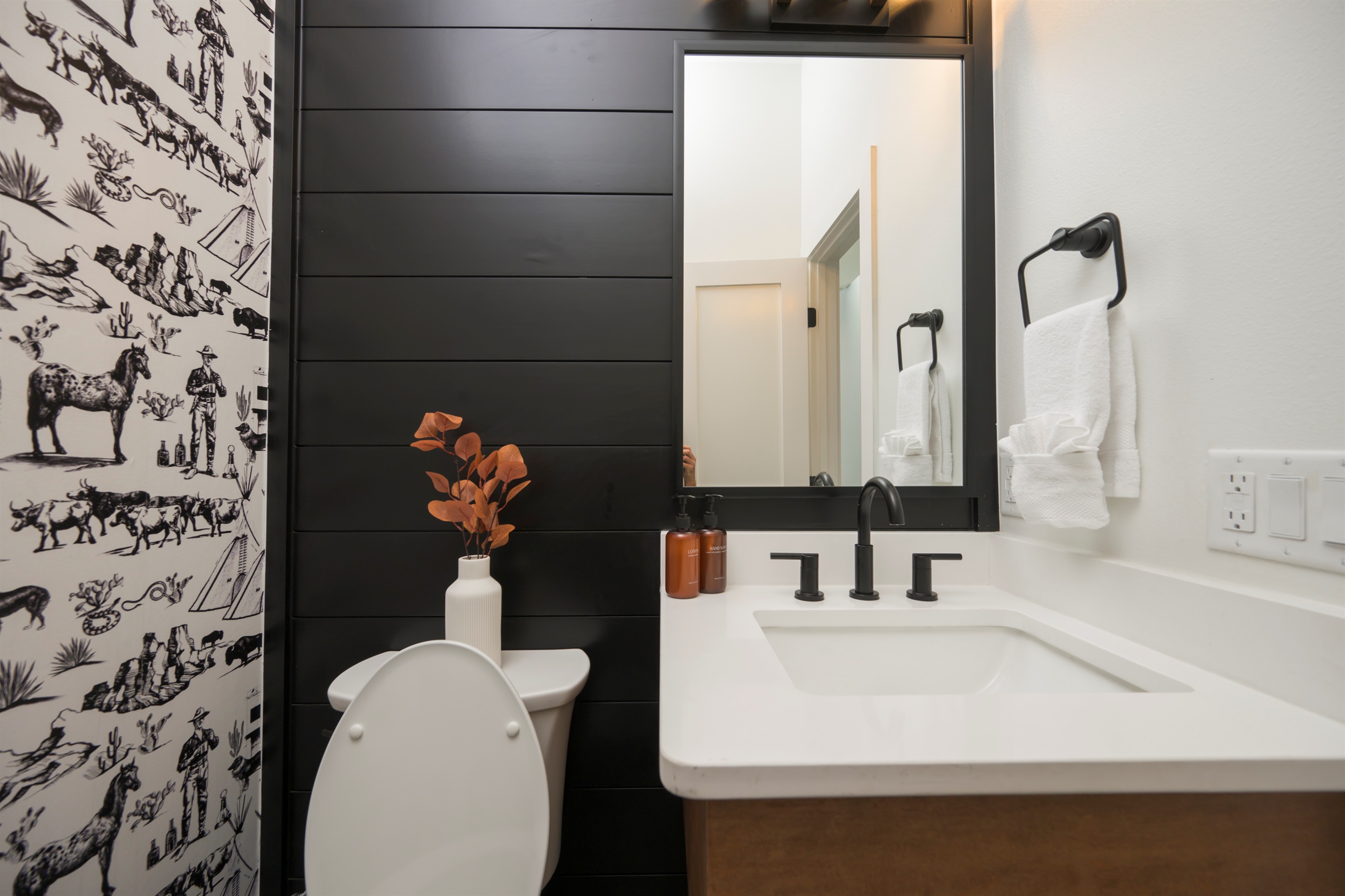 Half bathroom with chic modern design. Conveniently located near the main living area. 