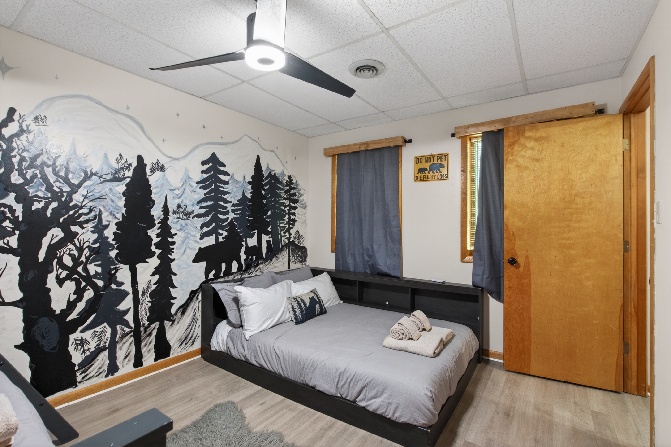 Bedroom 2 Retreat: A whimsical mural sets the scene in this comfortable, serene space!