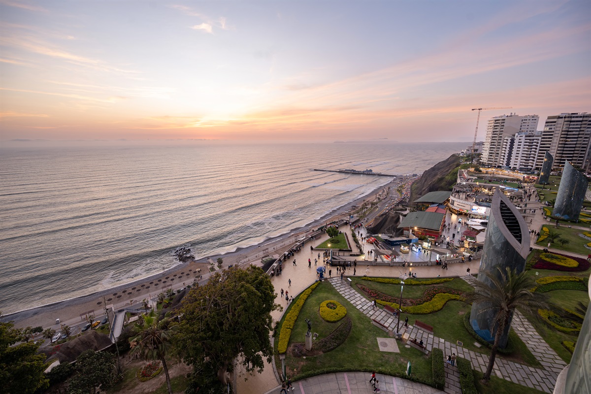 (Photo taken from apartment balcony) View from the living room at evening. World-Class Sunsets: Your private front-row seat to the most magical golden hours in Lima, right from your unique curved balcony