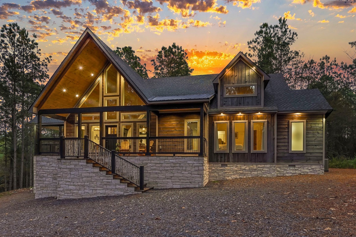 Rear exterior showcasing outdoor spaces and lighting.