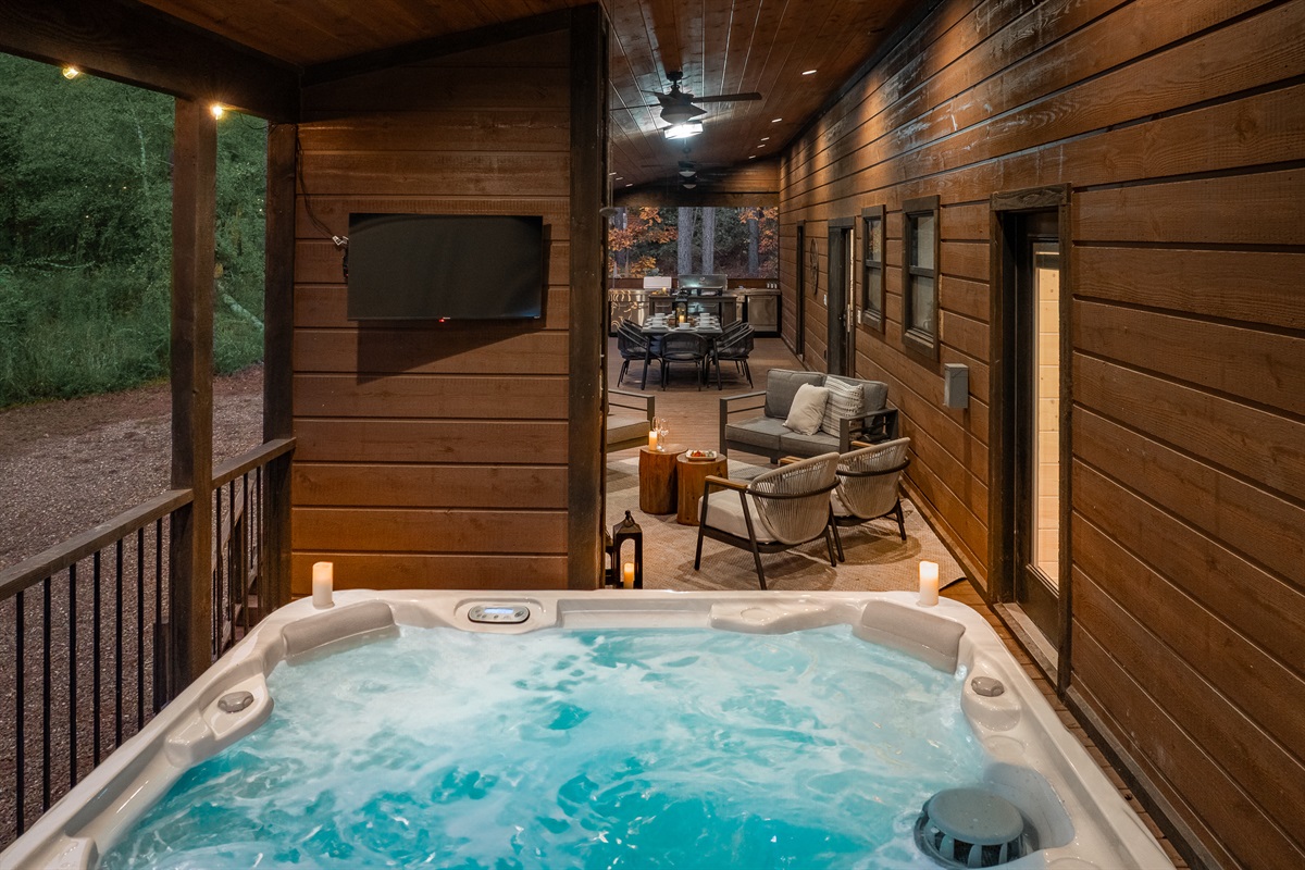 Your own private spa moment. Slip into the hot tub and enjoy a clear view of the outdoor TV while being surrounded by the calming forest.