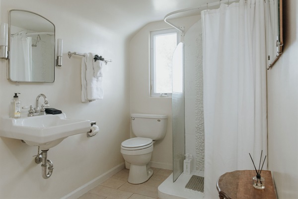 Custom tiled shower, orginal vintage light fixtures and mirrors.