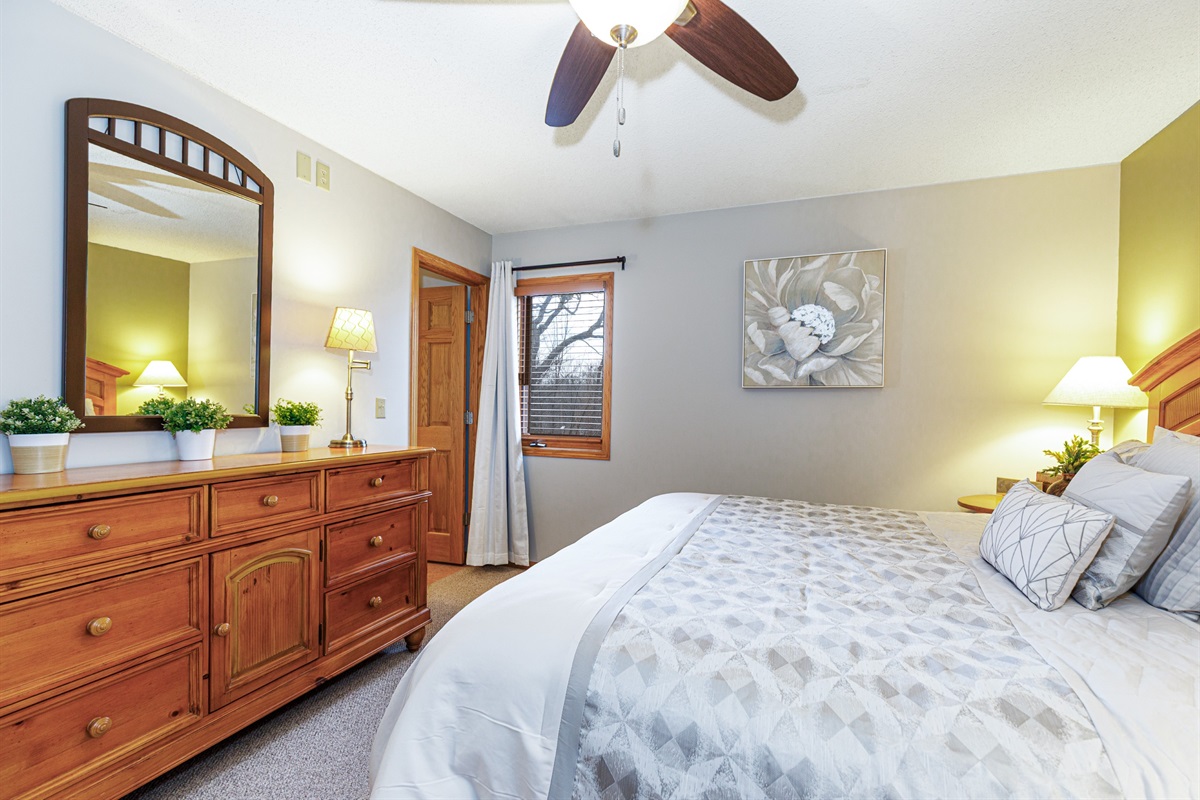 Main floor bedroom featuring a King bed and ensuite bathroom 