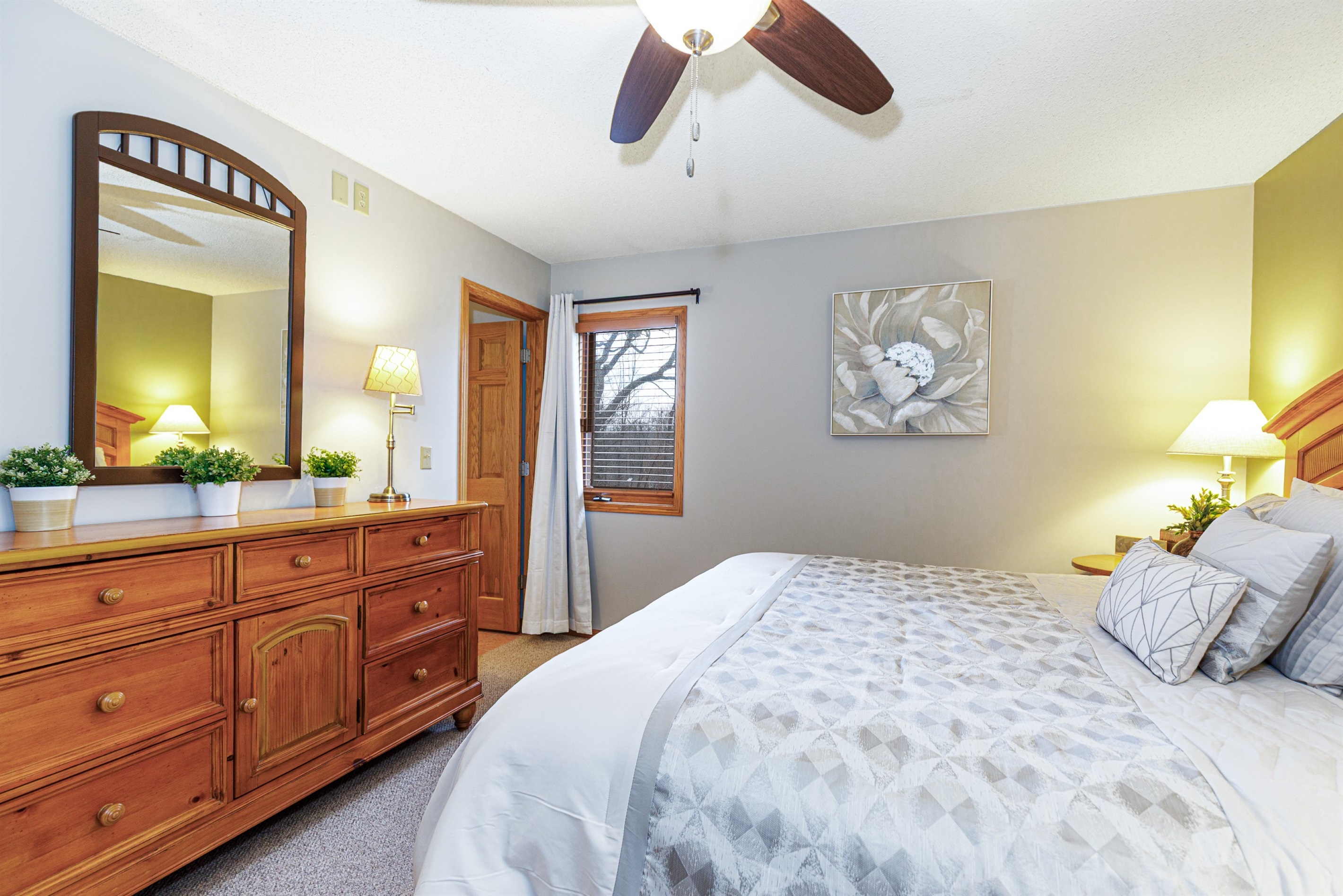 Main floor bedroom featuring a King bed and ensuite bathroom 
