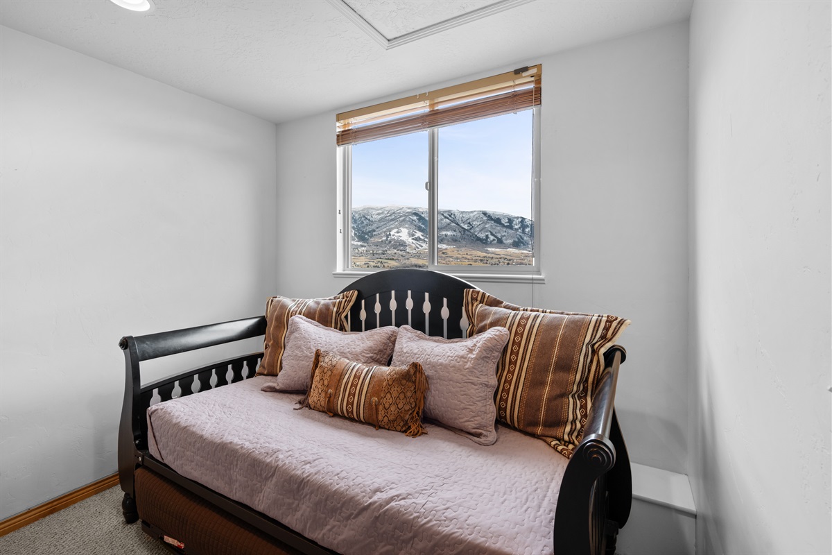 Comfortable daybed with trundle in the primary bedroom — perfect for relaxing, reading, or extra sleeping space.