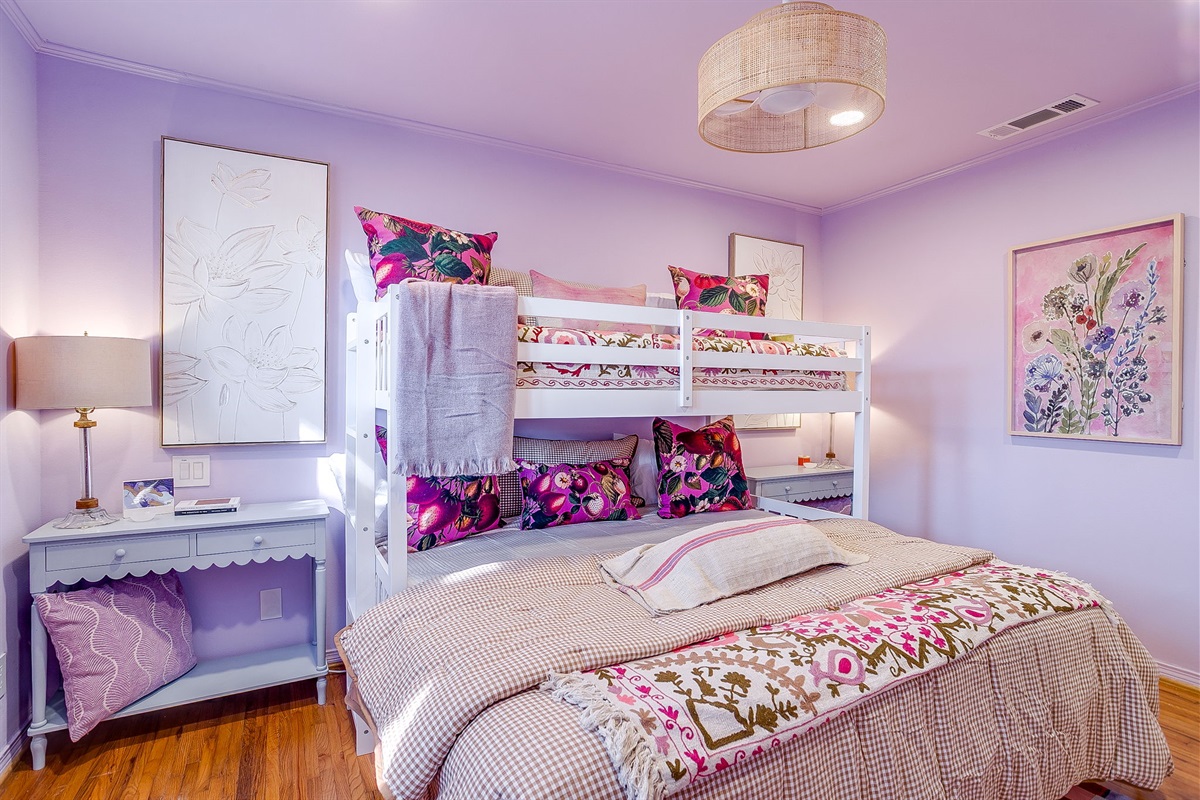 Bedroom Three: bold color, king bunk comfort, a breezy boho fan overhead, and enough pillows to make everyone claim top bunk.