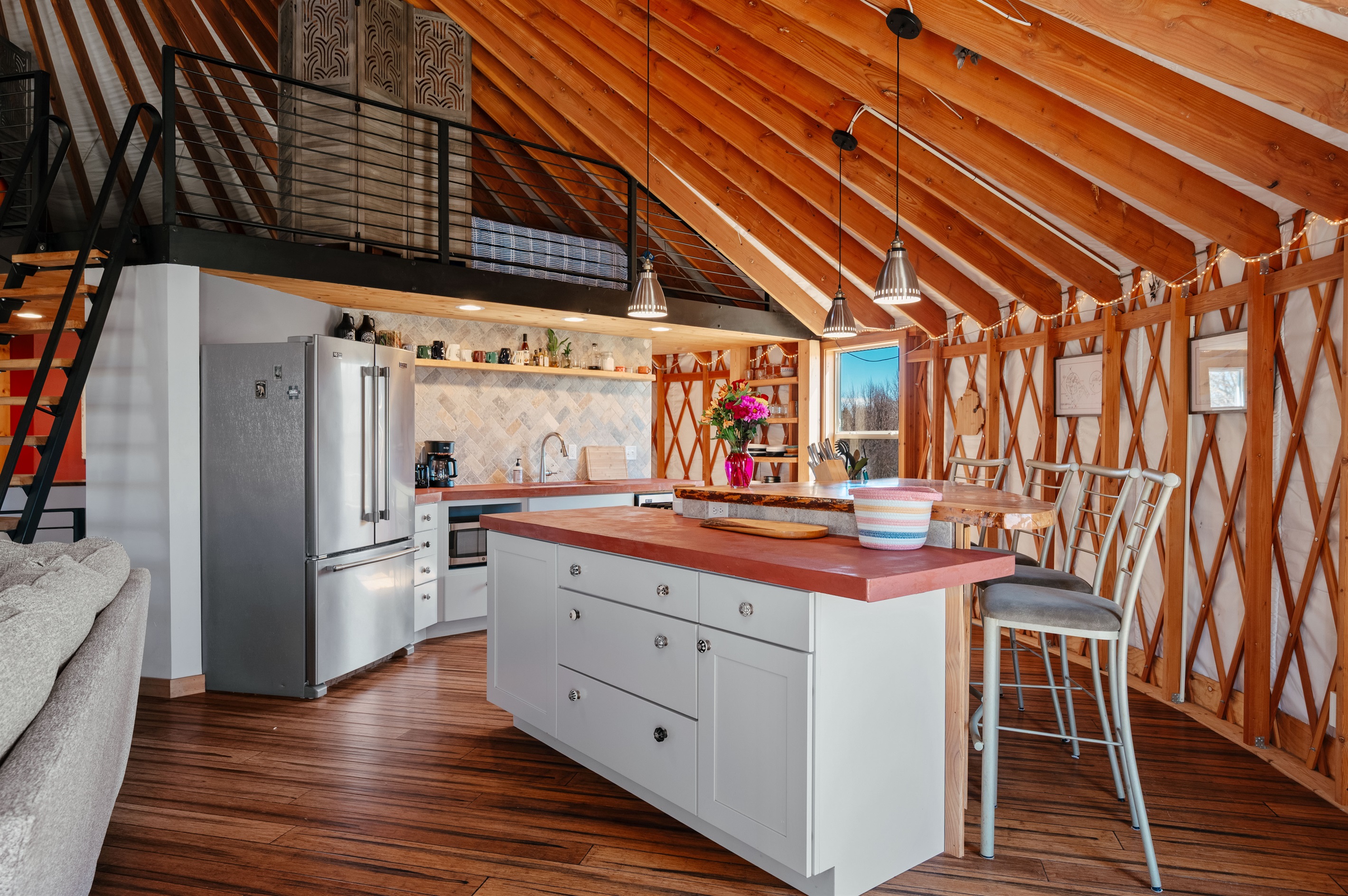 Beautiful open-concept kitchen featuring custom countertops, modern appliances, and a spacious island perfect for gathering, cooking, and entertaining.