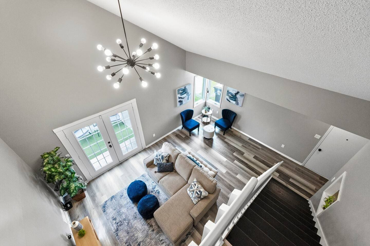 Stunning aerial view showcasing the expansive, open-concept living room with comfortable seating and stylish decor.