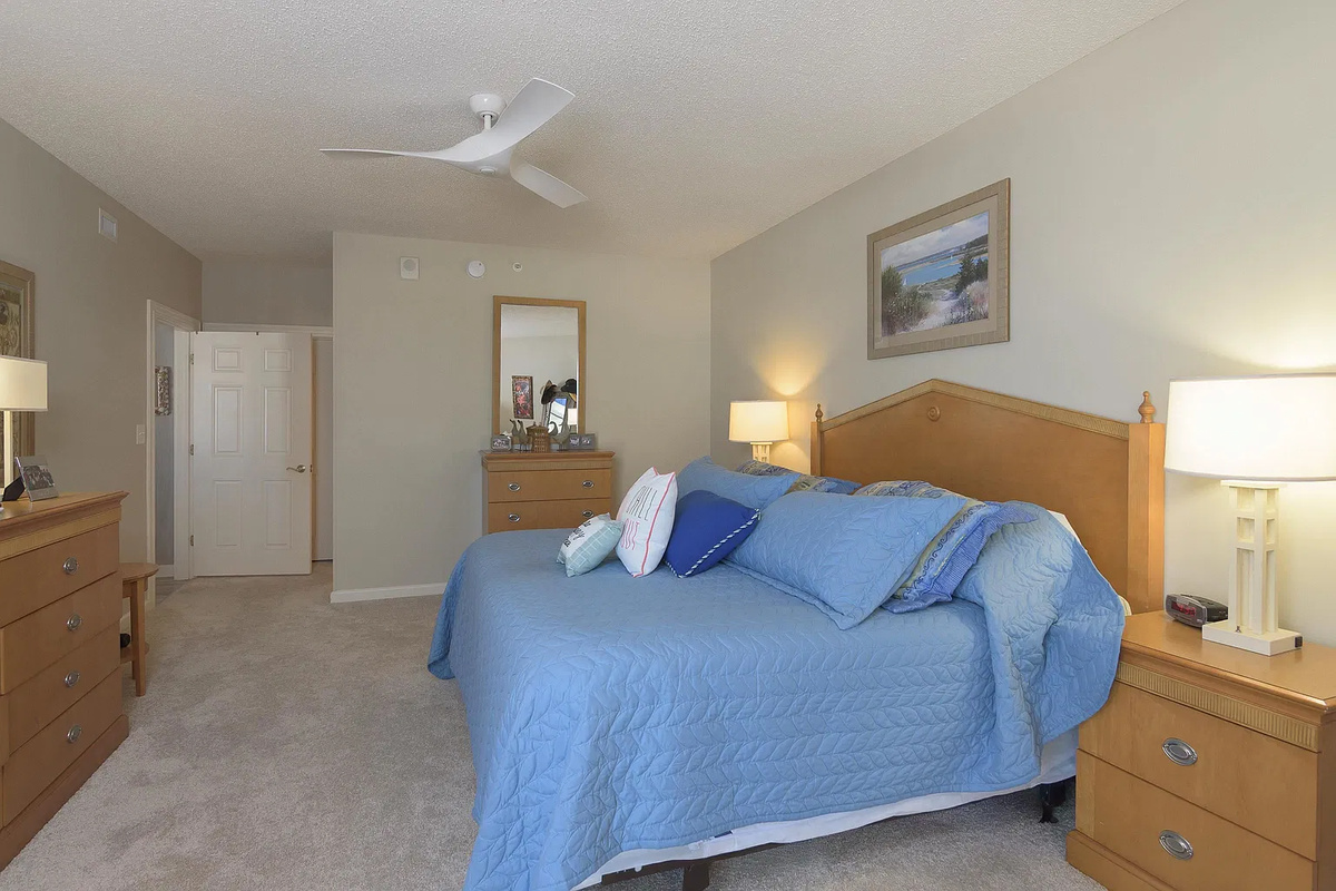 Spacious main bedroom with king bed, balcony access and ensuite