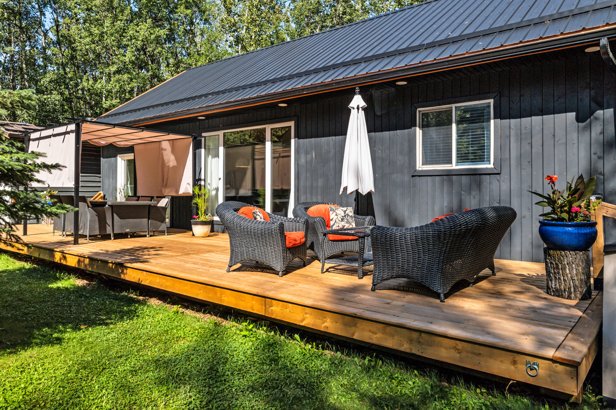 The spacious 12x44' front deck gives everyone room to spread out, dine outdoors, and enjoy the peaceful wooded setting.