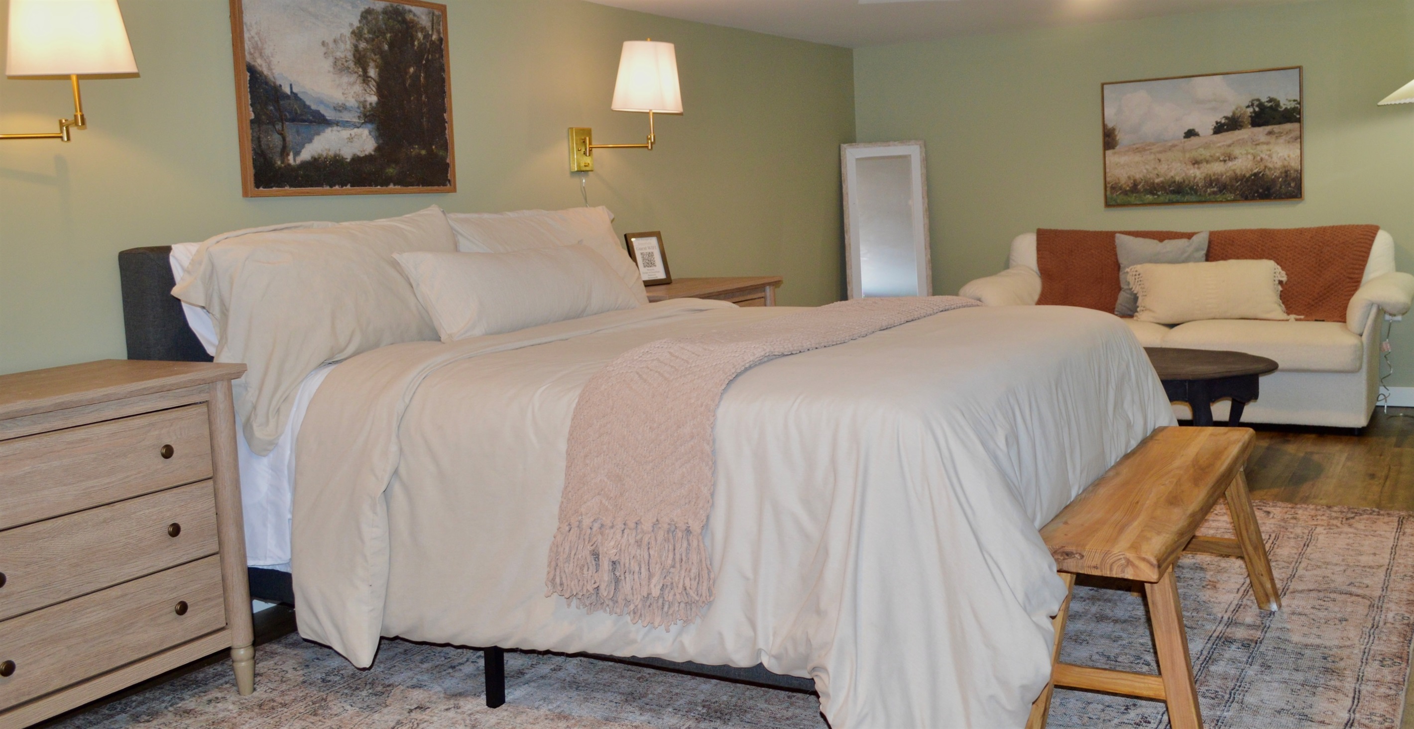 Open layout with queen bed and comfortable seating area